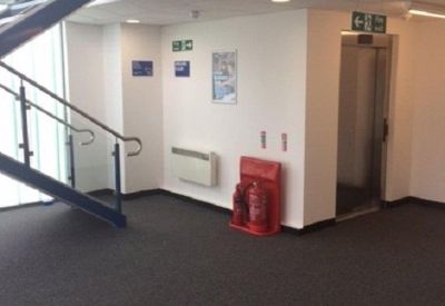 Lobby area featuring a modern metal staircase and an elevator entrance.