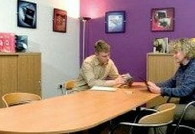 Team meeting at Unit K70, Chapel Place, Abington Square, Northampton with a purple feature wall.