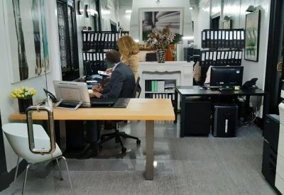 Professional administration area with several workstations and organized document storage.