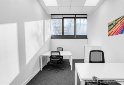 Private office suite with two desks and a colorful abstract wall art piece.