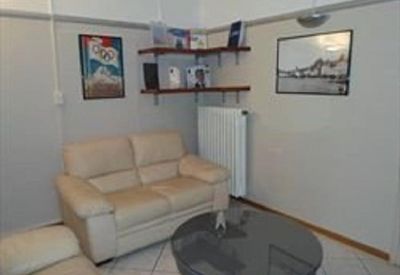 Lounge area with a cream leather sofa and a glass-topped coffee table.