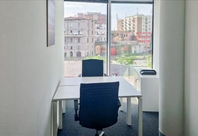 Minimalist reception desk with a white counter and a glimpse of an accent plant.