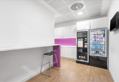Breakout area with vending machines, a breakfast bar, and vibrant purple splashback.