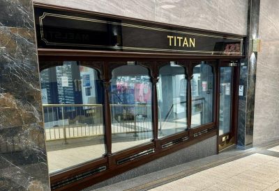 Entrance to Victoria Court featuring dark wood framing and large glass windows.