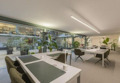 Modern workspace with multiple workstations and integrated strip lighting.