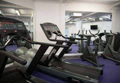 Gym facility with treadmills and exercise bikes.