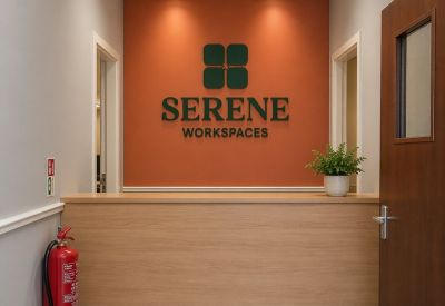 Branded reception area with a wooden desk and orange accent wall.