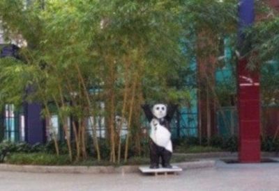 Indoor communal area with greenery and sculpture.
