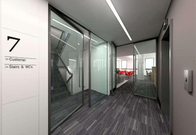 Modern office corridor with glass partitions, grey carpet, and a white wall marked with the number seven.