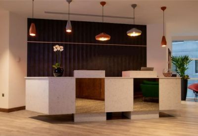 Reception desk with modern design and pendant lights.