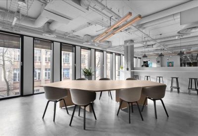 Spacious communal dining area with a large wooden table and high-top bar seating.