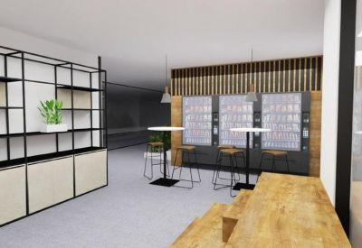 Communal break area with tall tables, bar stools, and vending machines.