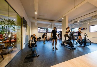 Modern on-site gym facility with rowing machines and exercise bikes.