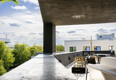 Outdoor terrace with modern seating and views of the surrounding greenery.