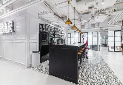 Stylish bar area with black cabinetry, brass pendant lights, and patterned tile flooring.