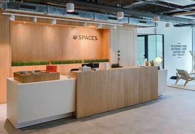 Bright reception area featuring a light wood front desk and branded back wall.