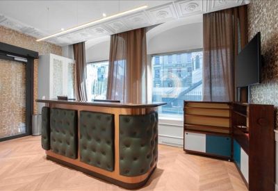 Reception desk featuring a tufted leather front and warm wood accents.