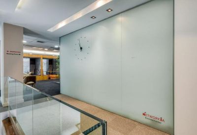 Frosted glass reception wall with a clock and company branding.