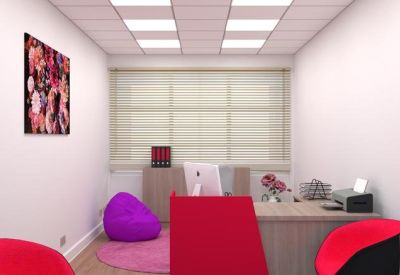 Private office featuring a pink rug, purple beanbag, and bright red chairs.