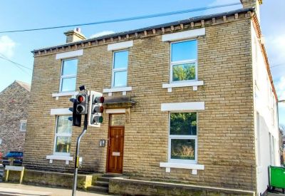 Exterior stone facade of the Prospect Road, Ossett, West Yorkshire building with large windows.