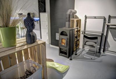 Breakout space featuring a wood-burning stove and a wooden crate shelf.