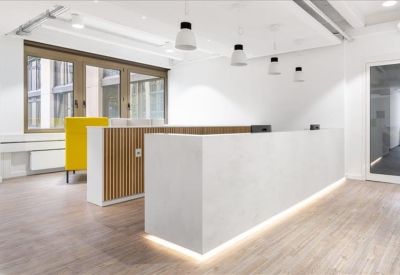 Minimalist white reception desk with integrated lighting and wood-paneled accents.