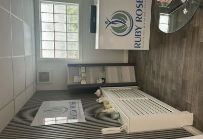 Professional reception area featuring a branded desk, wood flooring, and a decorative radiator cover.