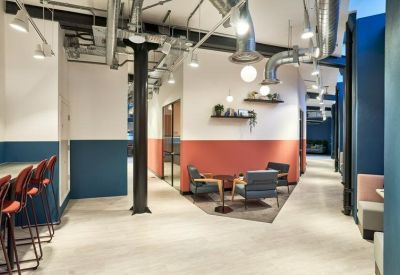 Spacious communal lounge at Rivington House, 82 Great Eastern Street, featuring industrial ceilings and colorful walls.