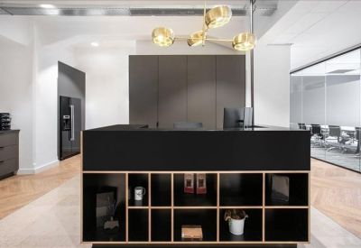 Modern reception desk with built-in shelving and a gold branch-style chandelier.