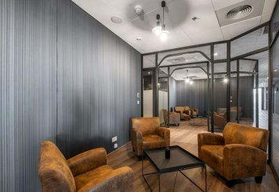 Internal lounge area featuring leather armchairs and dark wood-paneled walls.