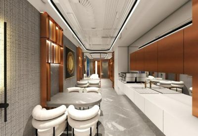 Stylish communal kitchen and dining area with copper cabinetry and modern circular seating.