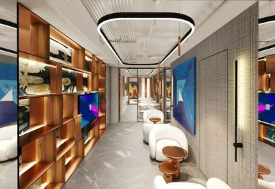 Executive meeting lounge with plush white armchairs, wooden shelving, and vibrant blue artwork.