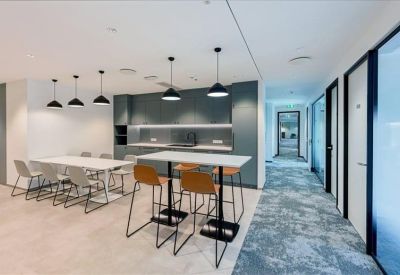 Spacious communal kitchen and dining area with high tables and modern pendant lighting.