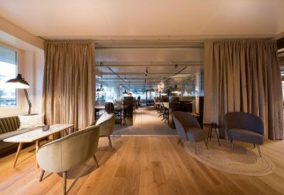 Comfortable lounge area with armchairs and natural light.