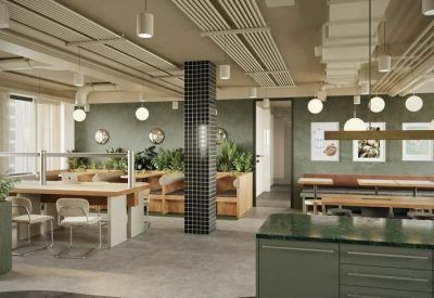 Bright open-plan workspace with a tiled pillar, booth seating, and hanging plants.