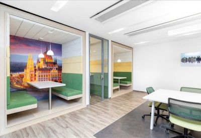 Private meeting booths with colorful mural walls and green bench seating.