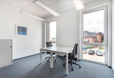 Bright private corner office with two desks and large windows.