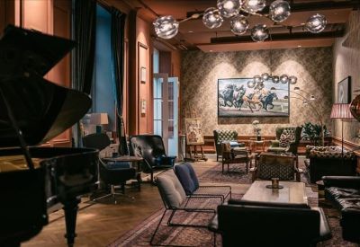 Sophisticated lounge area with a grand piano and velvet seating.