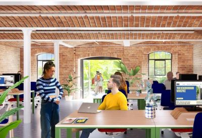 Modern open-plan office featuring vaulted brick ceilings, large windows, and green-trimmed desks.