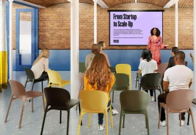 Spacious presentation room with vaulted brick ceilings and rows of colorful seating facing a screen.