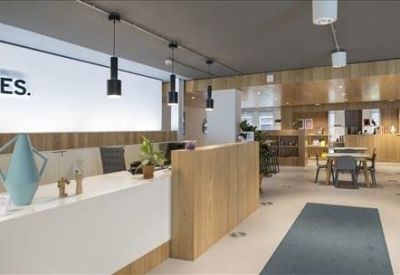 Modern breakout space featuring a private acoustic seating booth and indoor plants.