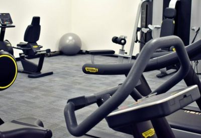 Gym area featuring stationary bikes, a treadmill, and an exercise ball.