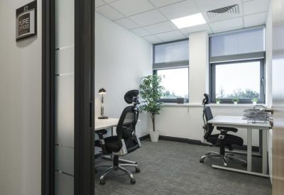 Private two-person office suite with ergonomic chairs and ample natural light.