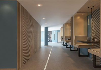 Communal hallway featuring semi-private wooden work booths with integrated lighting.