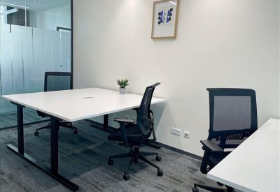 Private office with two white desks and black mesh ergonomic chairs.