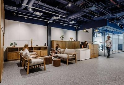 Lounge area with mid-century style armchairs and warm wooden wall paneling.