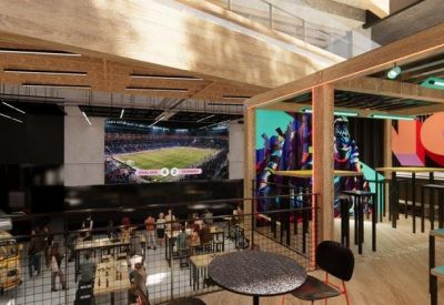 Modern cafeteria and lounge area with colorful wall murals and wood-beamed ceilings.