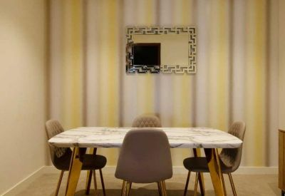Dining area featuring a marble-topped table and striped feature wallpaper.