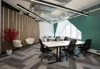 Professional meeting room with a large white table and dark grey wall.