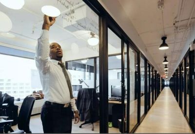 Office hallway with glass walls leading to individual offices.